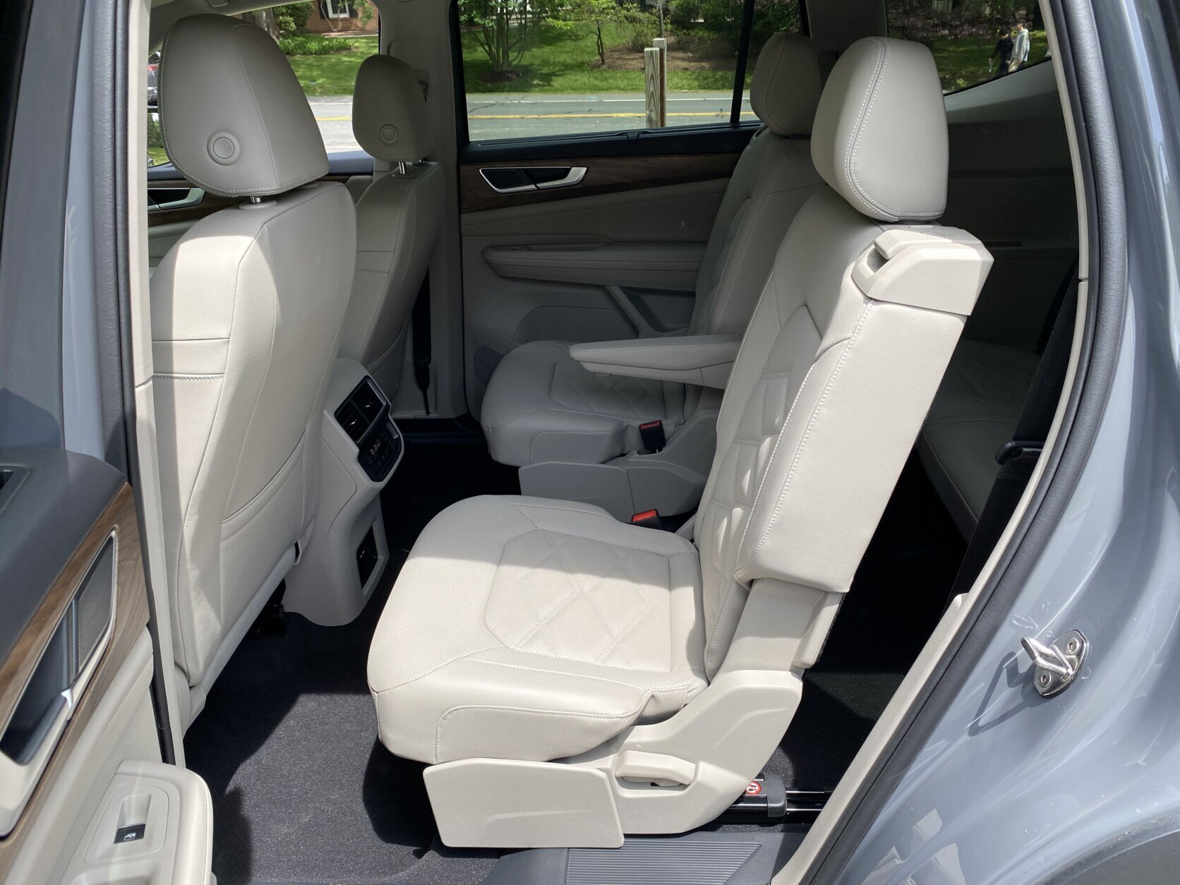The interior is interesting, featuring trim that looks like wood and brushed aluminum, along with piano black bits